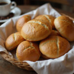 Freshly baked Pan de Bono in a basket with Colombian coffee.