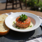 Deliciously plated Tartar de Fuet served with crusty bread.