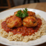 Finished dish of Grandma's Chicken Thighs in Tomato Sauce served over rice.