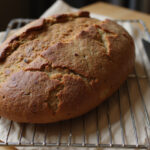 Freshly baked Pan De Centeno cooling on a rack.