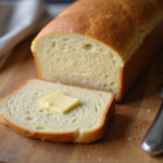 Freshly baked keto bread slices with butter, showcasing Pan Keto recipe.