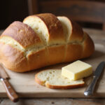 Freshly baked Pan de Trigo Sarraceno slices with butter, ready to eat.