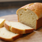 Freshly baked sliced Keto Bread with butter, ready to eat.