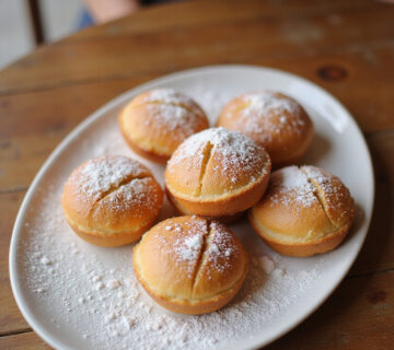 Delicious Xuxos de crema catalanes sprinkled with sugar, a traditional dessert.