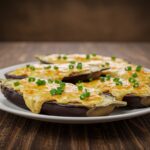 Finished berenjenas al horno con queso, an inviting dish perfect for sharing.