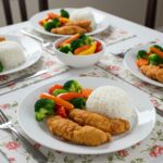 Tiras de pollo con miel y ajo servidas en la mesa, perfectas para una cena familiar.