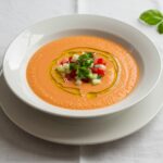 Beautifully presented gazpacho andaluz fácil bowl, rich in color and texture, ideal for a refreshing meal.