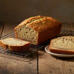 Finished Pan de Banana Sin Harina loaf on a wire rack, perfect for healthy snacking.
