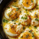 A close-up of baked eggs in individual ramekins, topped with crumbled white feta cheese and fresh herbs, golden brown edges, presented on a rustic wooden table with a warm, inviting ambiance.
