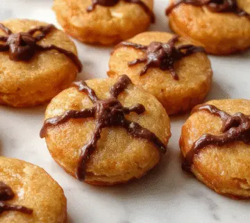 A close-up of Halloween-themed sugar cookie bars with vibrant orange and black icing, decorated with spooky sprinkles and ghost-shaped candies. The bars are neatly sliced, revealing a soft, chewy interior and smooth glossy glaze on top. They are arranged on a festive Halloween platter with jack-o'-lantern accents in the background.