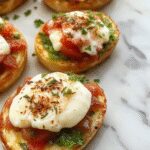 A close-up of a vibrant Italian bruschetta topped with creamy white burrata cheese, finely chopped tomatoes, fresh basil leaves, drizzled with olive oil, served on a rustic wooden platter with a toasted baguette slice visible.